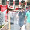 Tourists walk in front of a misting fan during a hot day on the Strip, Tuesday, Aug. 21, 2012.